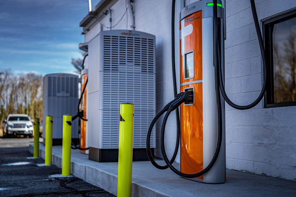 Commercial EV charging station with power equipment installed outside facility