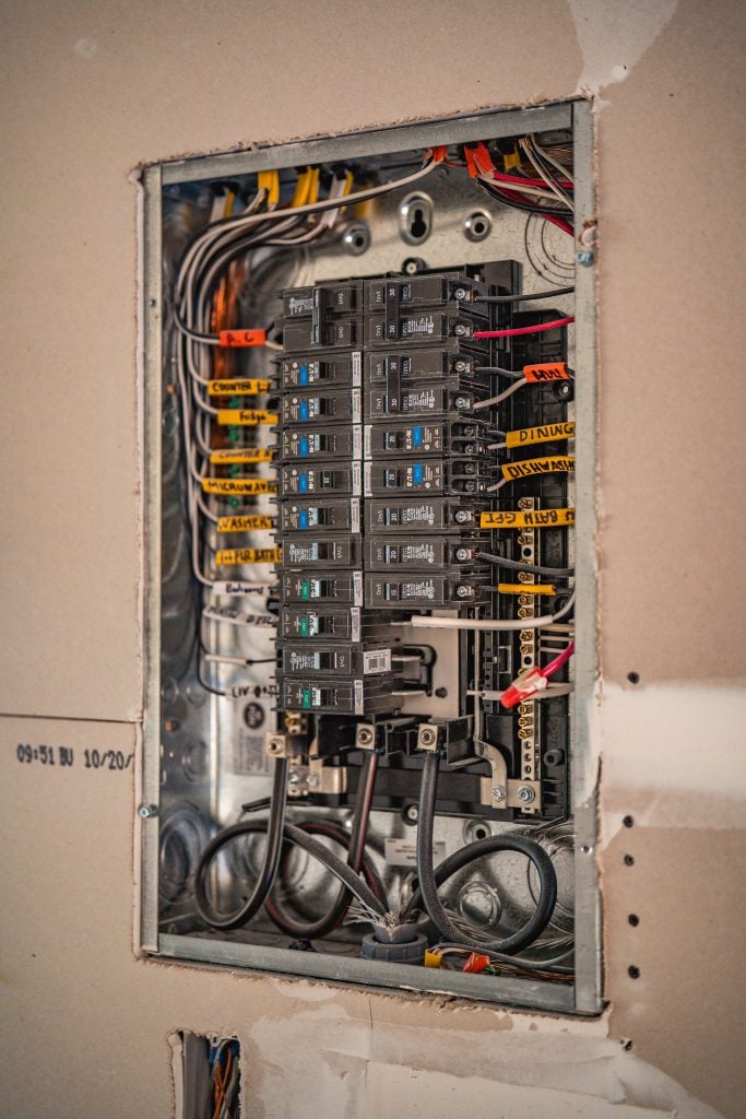 Interior view of residential electrical breaker panel with labeled circuits