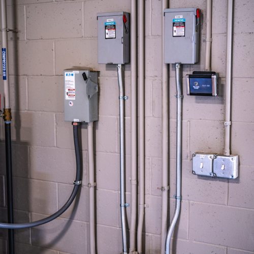 Wall-mounted electrical control boxes and conduit installation in commercial setting