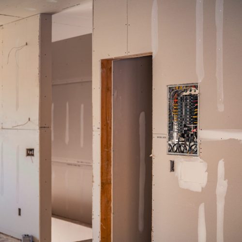 Partially finished interior with exposed electrical panel during home construction