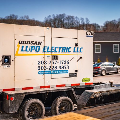 Lupo Electric mobile generator trailer at residential job site in winter
